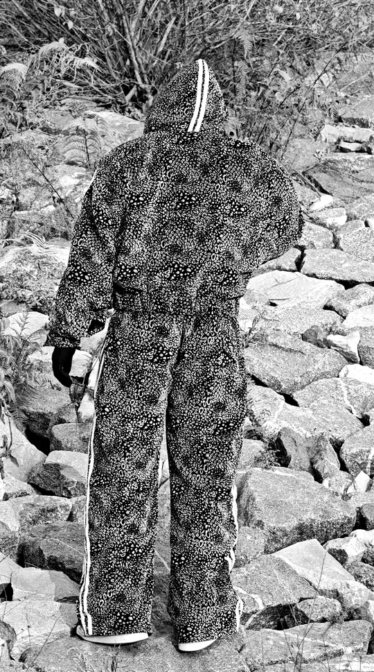The Roar hooded jacket worn on rocks